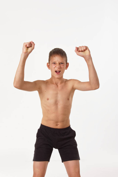 teenager with muscles. emotions of the winner - Φωτογραφία, εικόνα