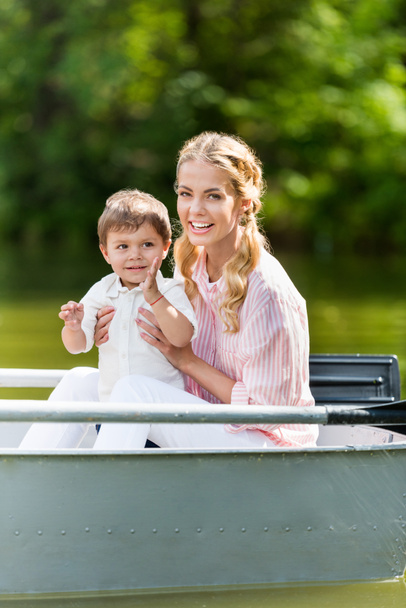 happy mother with son spending time together in boat at park - Foto, immagini