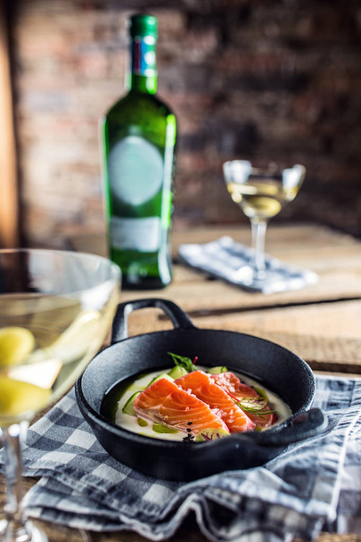 Marinated salmon with cream cucumber and dill in pan with aperitif. Culinary serving of meal in restaurant. - 写真・画像