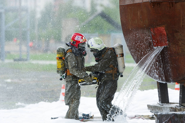Ćwiczenia ratowników w zakładach chemicznych, aby zapisać przemysłowa. Dwóch ratowników eliminuje skutki awarii chemicznych - Zdjęcie, obraz