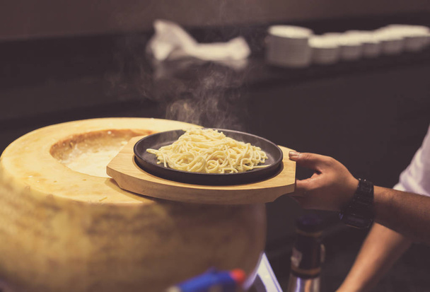 hand chef cooking with cheese and spaghetti. - 写真・画像