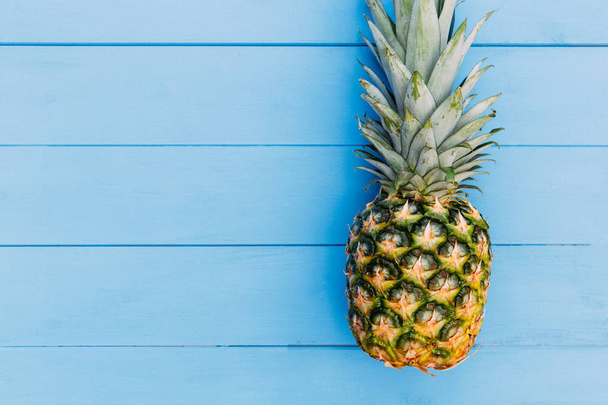 Pineapple fruit on blue wood table background - Photo, Image