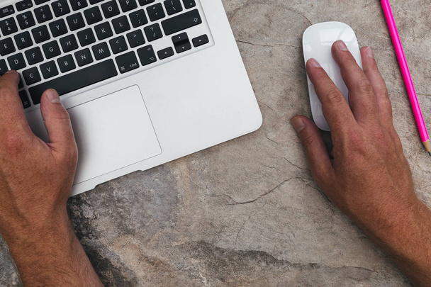 Homme travaillant avec ordinateur portable et souris sur fond de marbre
 - Photo, image