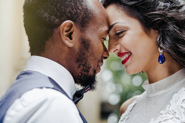 Wedding day. Stylish african groom and his pretty bride. African wedding couple emotional portrait loving bride and groom. - Photo, Image
