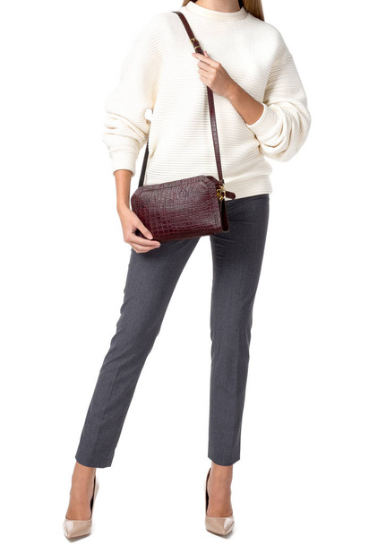 Woman holding a handbag isolated on white background - Foto, afbeelding