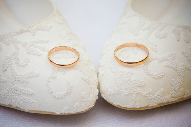 trouwringen op schoenen van de bruid - Foto, afbeelding