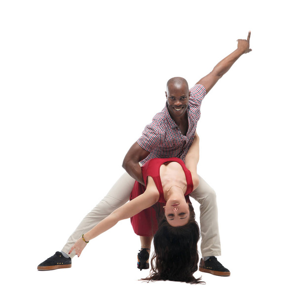 Black man and caucasian woman in casual clothes in incendiary dance isolated on white background. - Фото, изображение