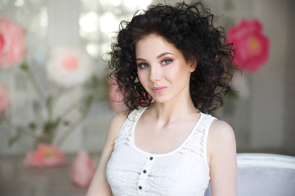 A nice young girl with brunette curls. - Foto, immagini