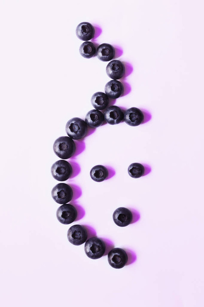 Creative bilberries composition ,light effect ,abstract photo , top view ,vertical composition ,studio shot   - 写真・画像