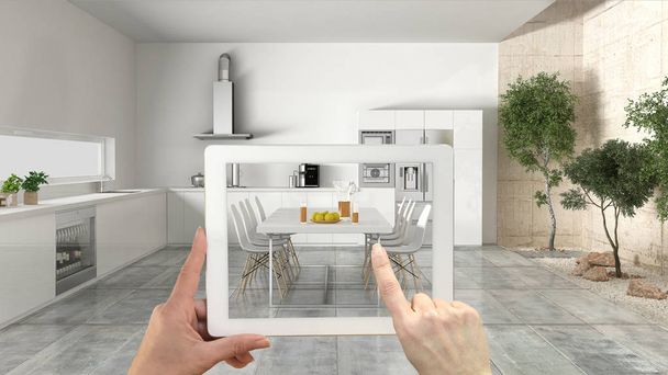 Concepto de realidad aumentada. Tableta de mano con aplicación AR utilizada para simular muebles y productos de diseño de interiores en el hogar real, cocina con jardín
 - Foto, Imagen