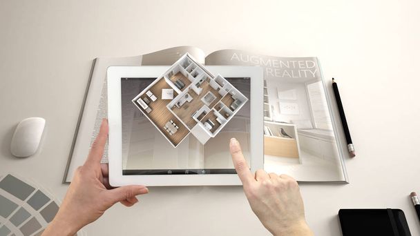 Augmented reality concept. Hand holding tablet with AR application used to simulate 3d pop-up interactive room maps to life - Photo, Image