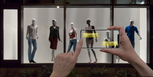 Augmented reality marketing concept. Hand holding digital tablet smart phone use AR application to check special sale price in retail fashion shop, mall interior design - Foto, Bild