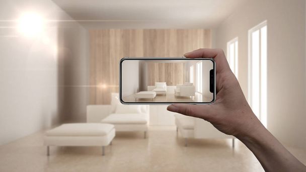 Ruka držící chytrý telefon, Ar aplikace, simulovat nábytku a interiérového designu výrobků v skutečného domova, architekt designový koncept, rozostření pozadí, moderní obývací pokoj - Fotografie, Obrázek