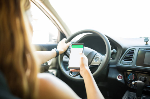Hand of female driver using maps on smartphone to find the right place to go - Photo, image