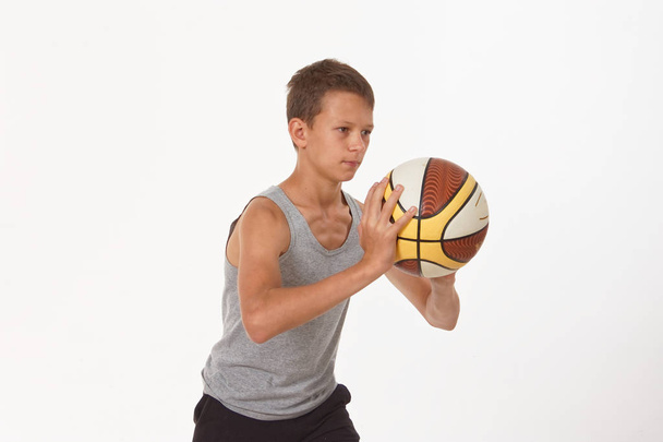teenager with a basketball on a white background - Photo, Image