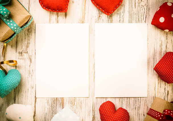 Love hearts and sheet of blank paper on wooden table - Valokuva, kuva