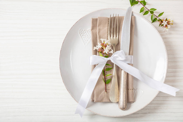 Holiday table place setting with plates, fork and knife, copy space - Foto, imagen