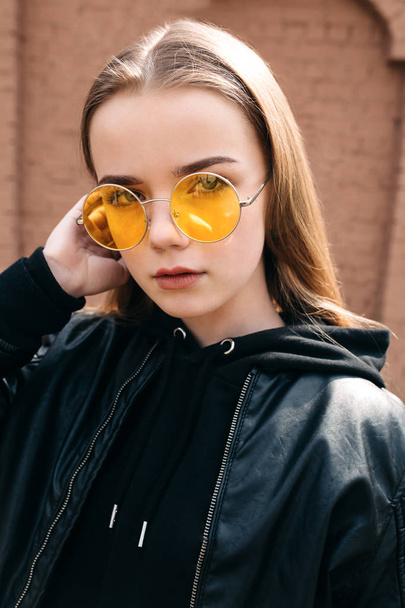 beautiful fashionable kid girl in yellow sunglasses in city - Valokuva, kuva