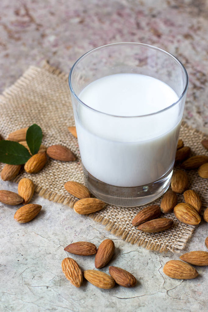 Almond milk in a glass. Organic vegan milk. - Foto, immagini