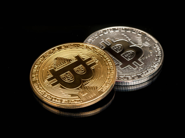 Gold and silver bitcoin coin on black background - Foto, Imagem