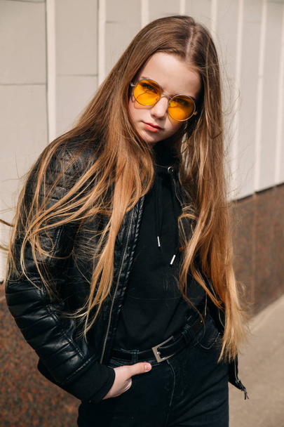 beautiful fashionable kid girl with long hair in yellow sunglasses in city, Street fashion kid, - Fotó, kép