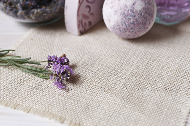 Lavender flowers, lavender soap, aromatic sea salt on wooden background - 写真・画像