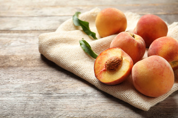 Fresh sweet peaches on wooden table. Natural fruit - Фото, изображение