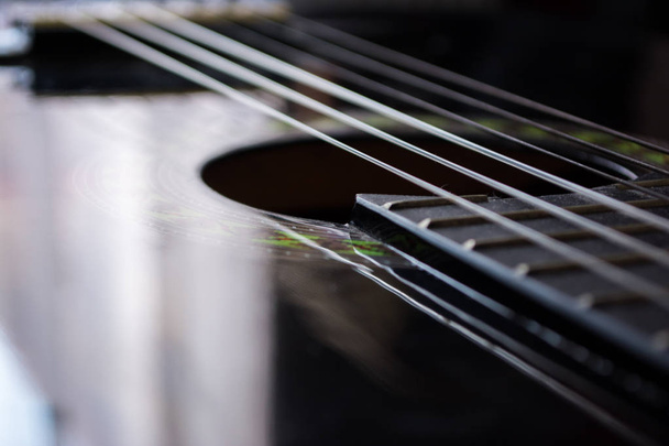 Detail of classic acoustic guitar with shallow DOF and blur. - Fotó, kép