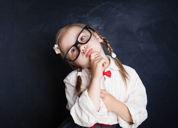 Smart school kid in glasses thinking. Back to school, Kid Creativity and Education Concept - Foto, immagini