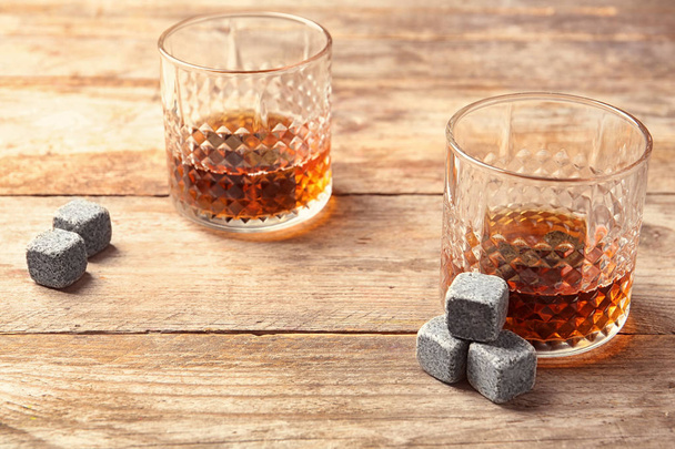 Glasses with liquor and whiskey stones on table - Valokuva, kuva