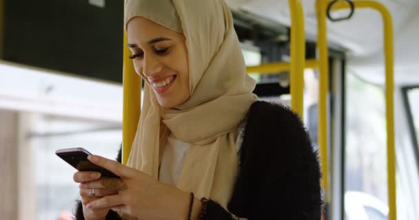 Woman in hijab using mobile phone in the bus 4k - Imágenes, Vídeo
