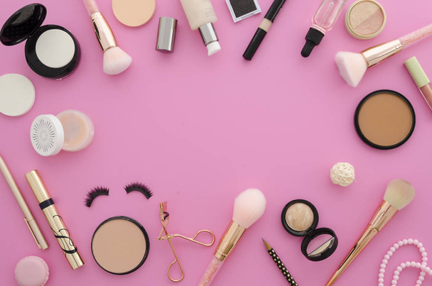Flat lay mockup cosmetics. Make up products frame on a pink background - Photo, image