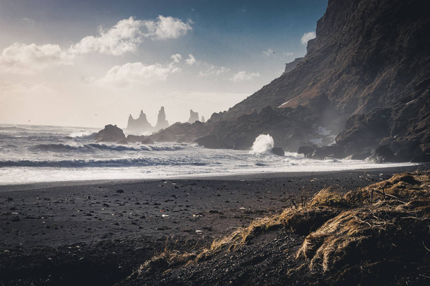 Sunrise at famous Black Sand Beach Reynisfjara in Iceland. Windy Morning. Ocean Waves. Colorful Sky. Morning Sunset. - Фото, изображение