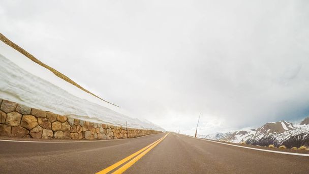 Driving on Trail Ridge Road on openning weekend of the season in Rocky Mountain National Park. - Photo, Image