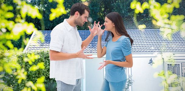 Angry brunette shouting at boyfriend against pretty house with a blue and white filter - Foto, Bild
