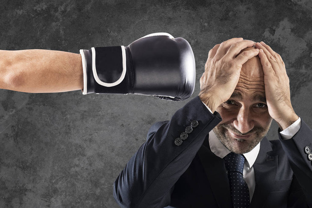 Businessman receives fists from competitors. concept of difficult career - Photo, Image