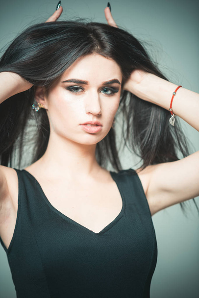 Hair care procedure. Girl enjoy softness freshness and gloss of hair after salon hair care. Woman brunette with makeup looks gorgeous. Lady touching hair. Beauty and hair care concept - Fotografie, Obrázek