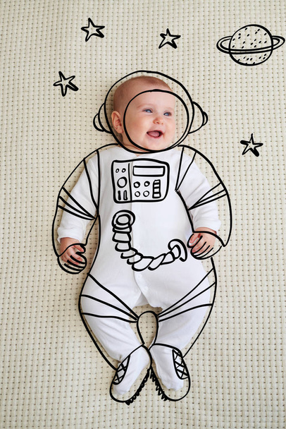 Cute infant baby girl sketched as astronaut - Foto, Imagen