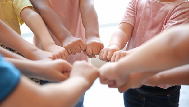 Little children putting their hands together, closeup. Unity concept - Photo, Image