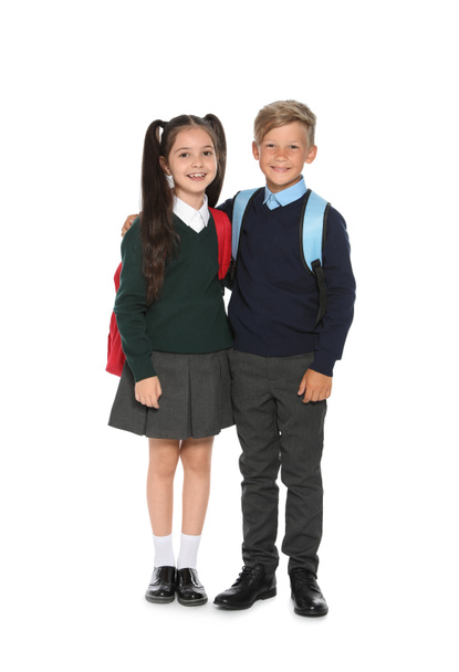 Little children in stylish school uniform on white background - Fotó, kép