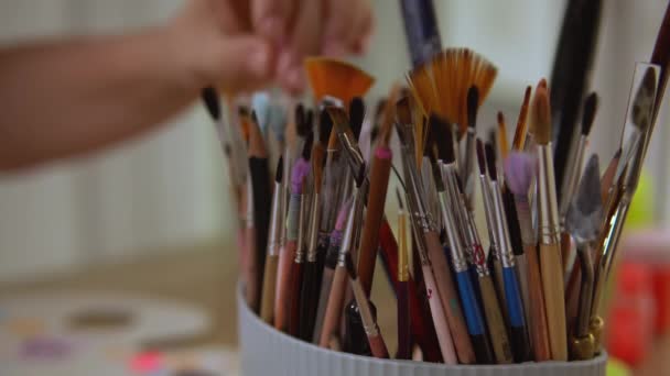 Artist finds exact paintbrush for her art design. - Footage, Video