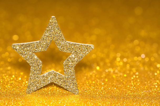 Shining star on a golden radiant background. Glitter shine with 3d shape - Фото, изображение