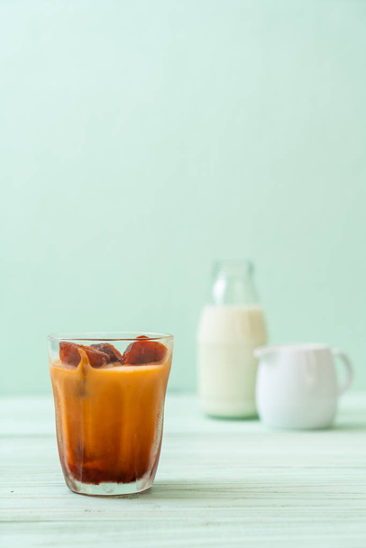 Thai tea ice cube with milk on wood background - Valokuva, kuva