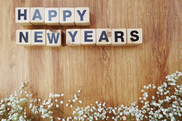 happy new years alphabet letters on wooden background - Фото, изображение