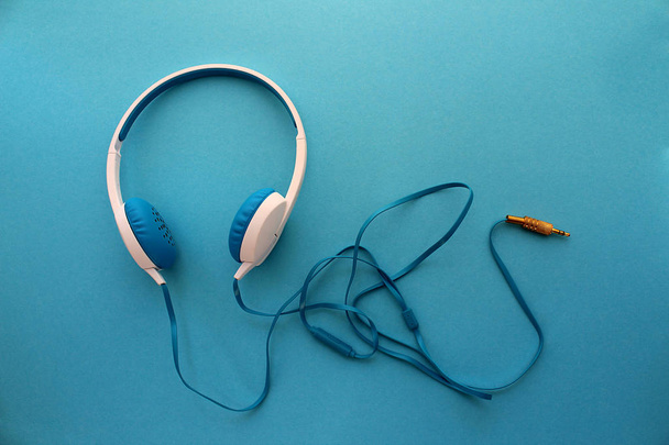 headphones blue color on the background of the same color - Foto, Imagem