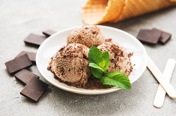 Plate with chocolate ice cream on a stone background - Photo, image