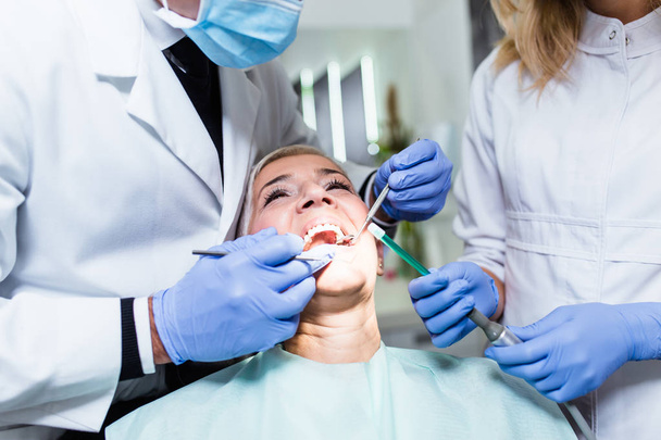 dentist and patient in dental clinic - Foto, Imagen