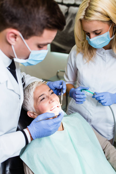 dentist and patient in dental clinic - Fotografie, Obrázek