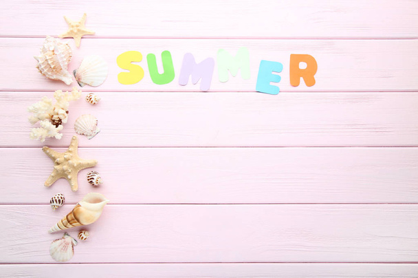 Inscription Summer with seashells on pink wooden table - Fotó, kép
