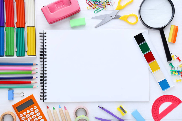 School supplies with blank sheet of paper on wooden table - Photo, image